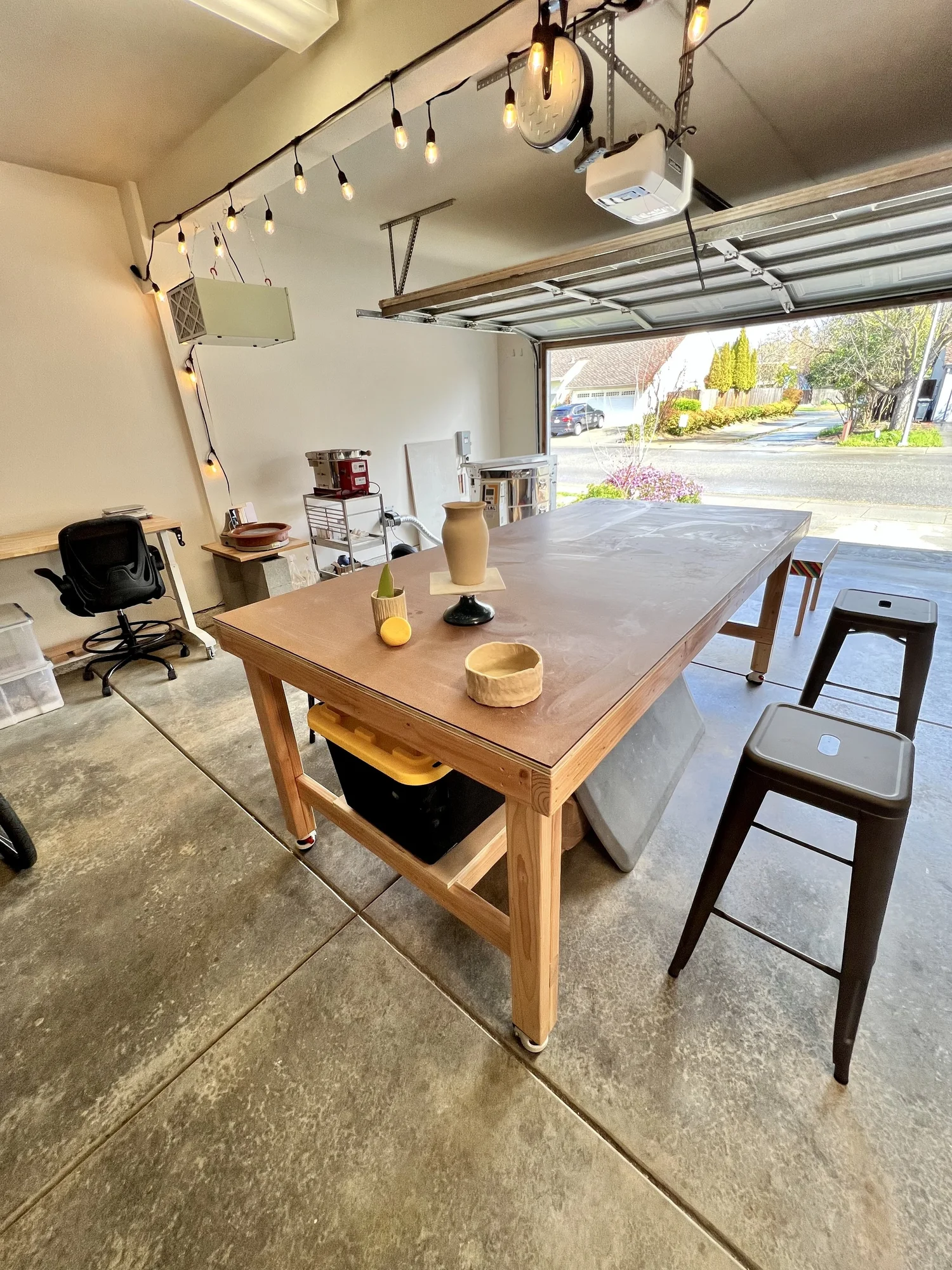 The large wooden work table in the garage studio