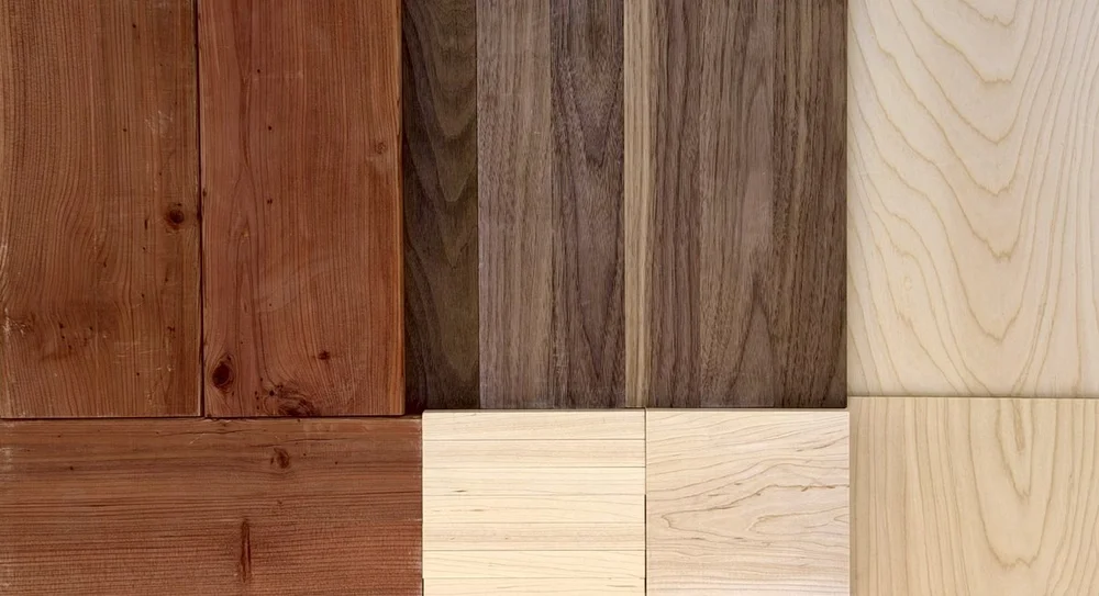 Pieces of redwood, walnut, maple, and birch plywood laid edge to edge