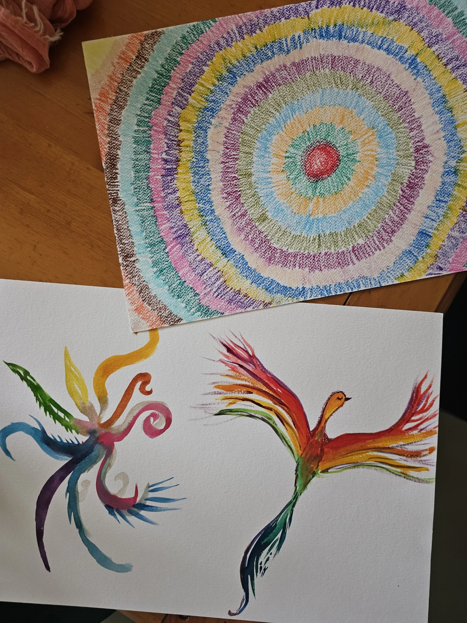 A hand-drawn mandala and a watercolor phoenix made during a circle