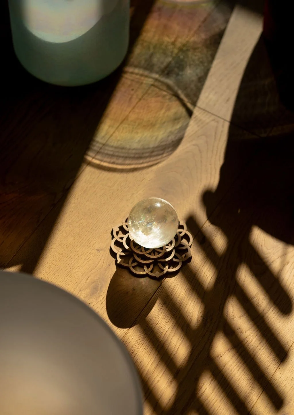 Crystal ball resting on a wooden mandala