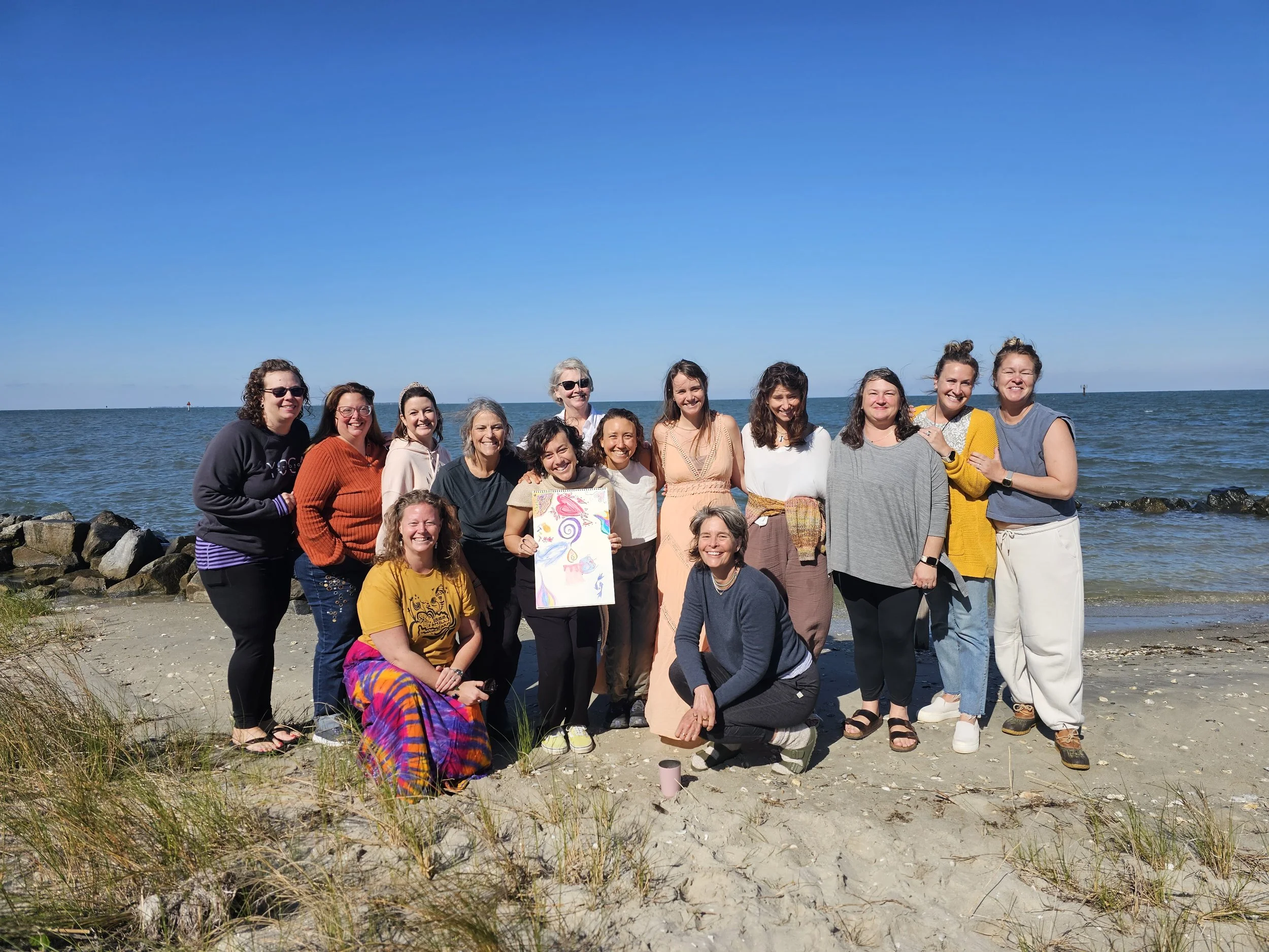 A circle of women standing together on the beach after ceremony, Ocracoke Island