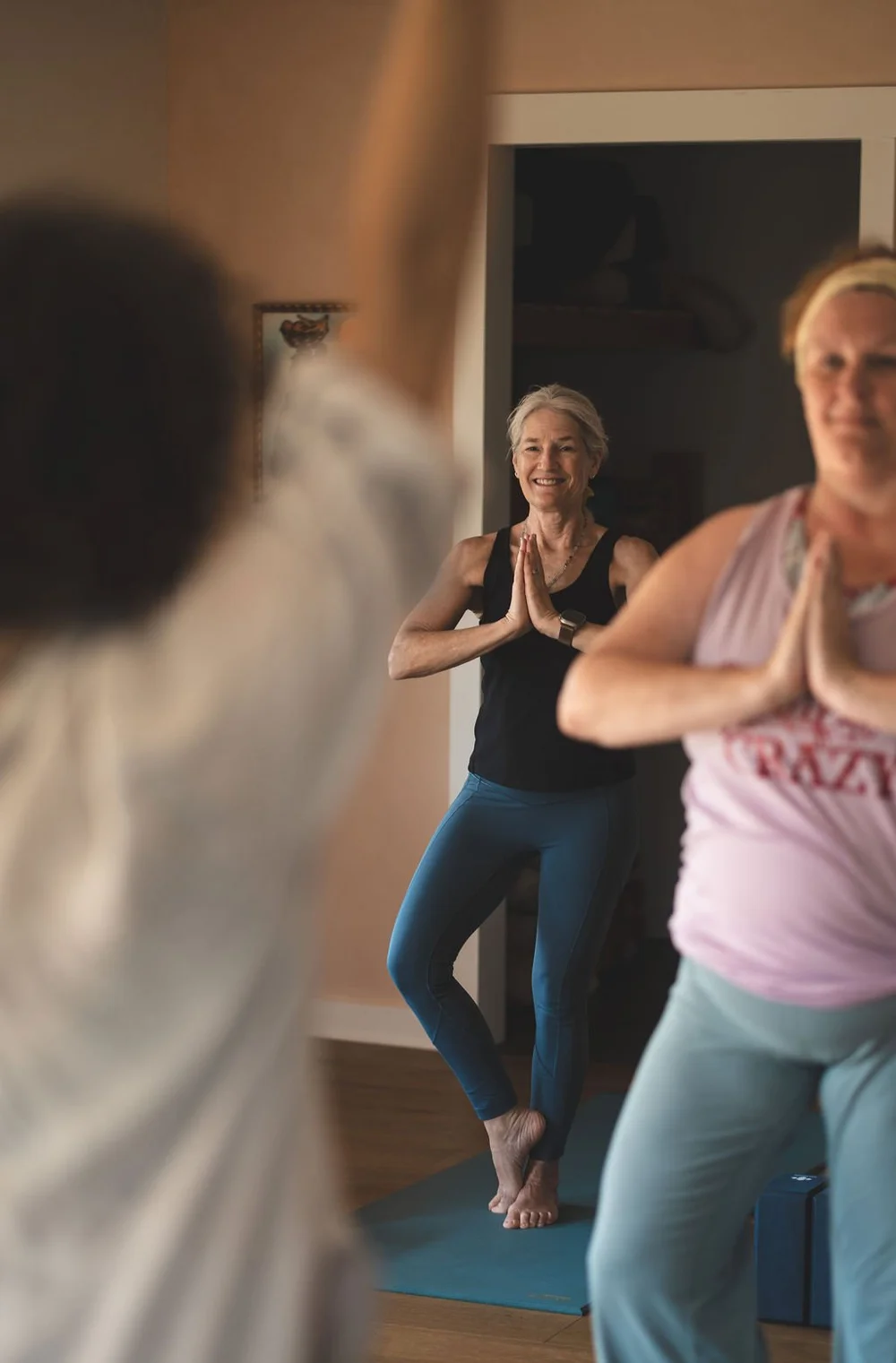 Women standing together, hands at heart