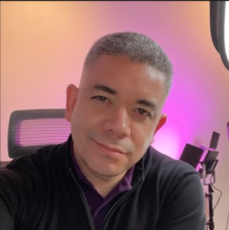 Jaime Rivera, smiling, in front of a purple-lit backdrop.