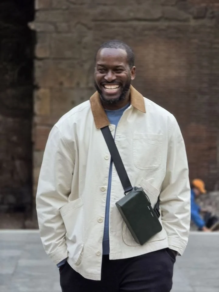 Booredatwork, photographed outdoors in a cream jacket.