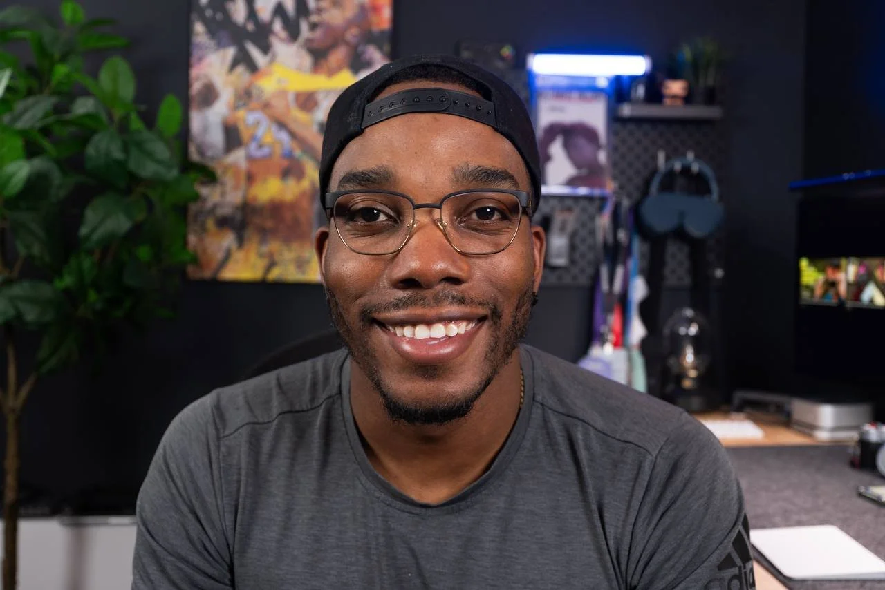 Shomar of ShoAndTech, smiling in glasses and a black cap.