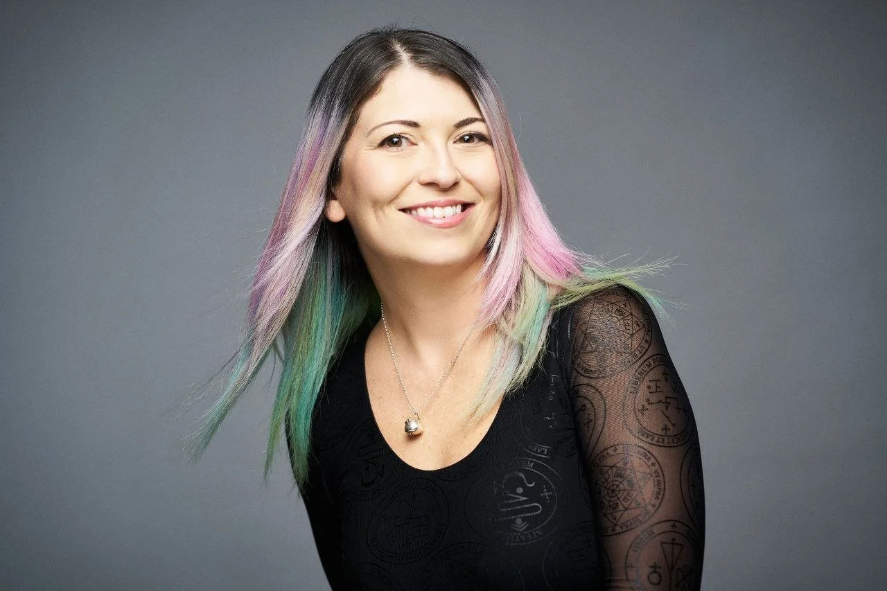 Shannon Morse, smiling, with pastel-streaked hair.