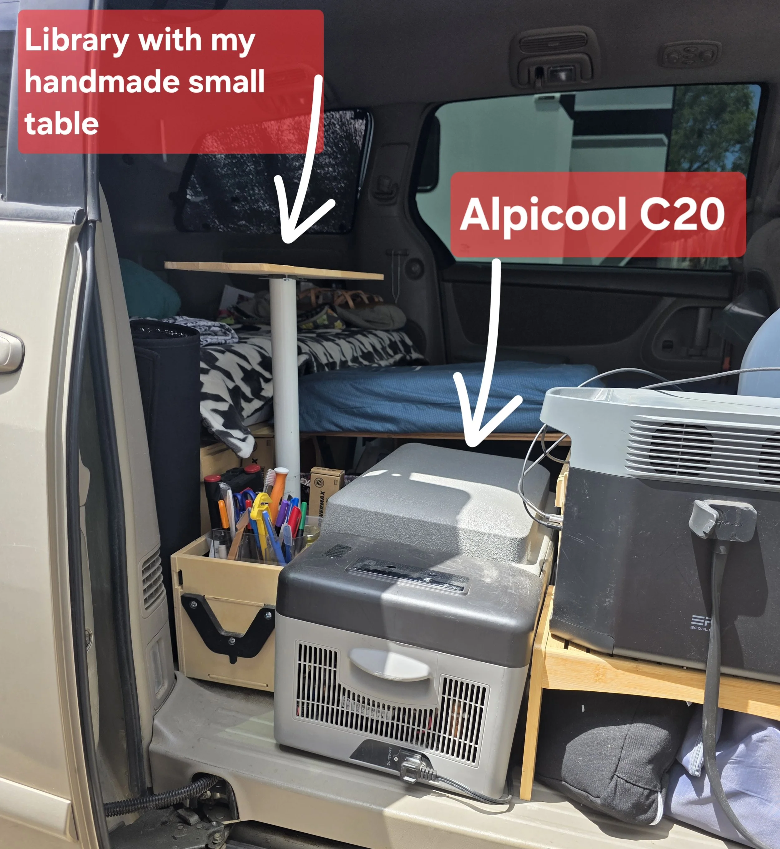 Refrigerator positioned in the opened middle space of the Roadloft minivan kit