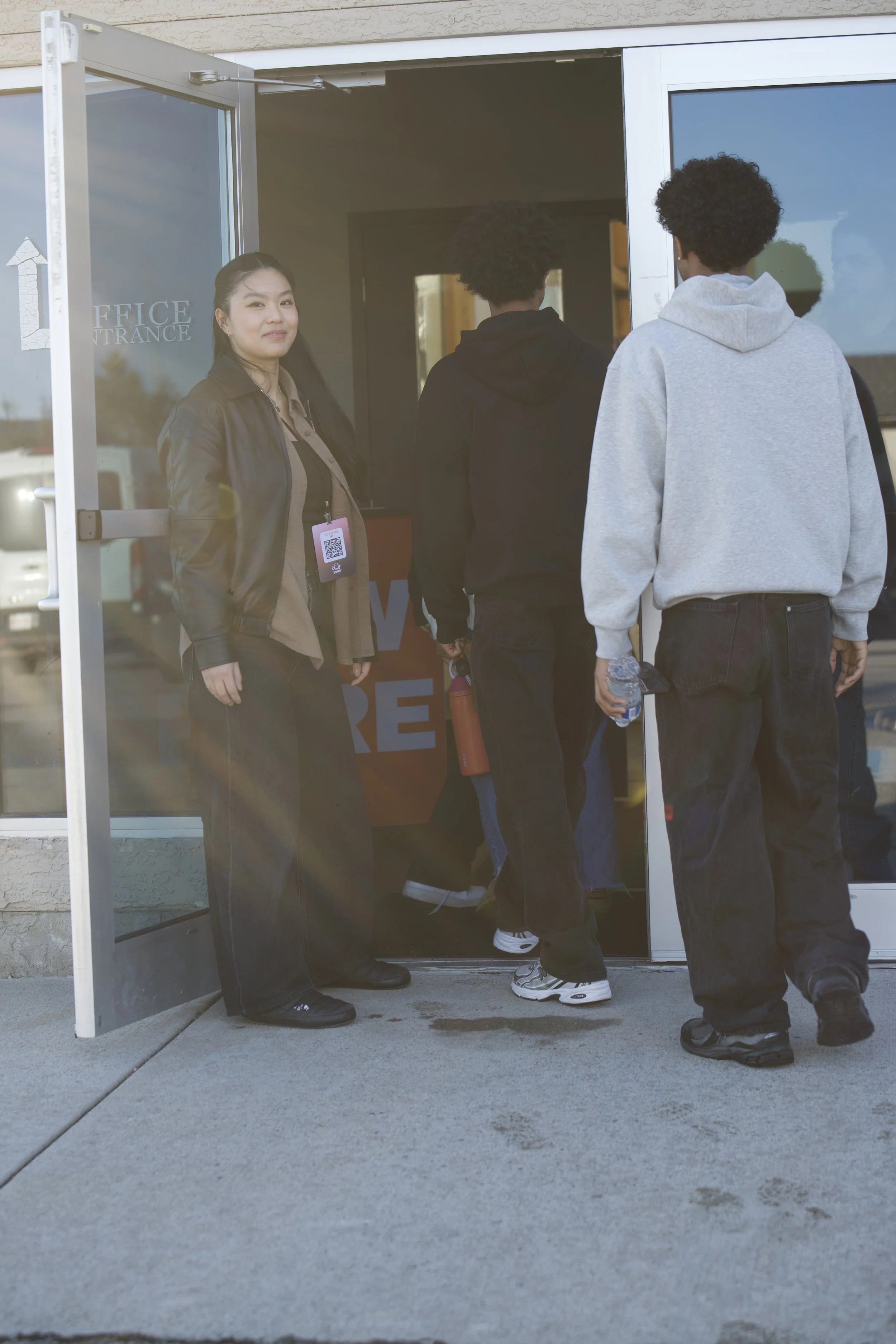 A greeter welcoming students at the doors of Journey Church