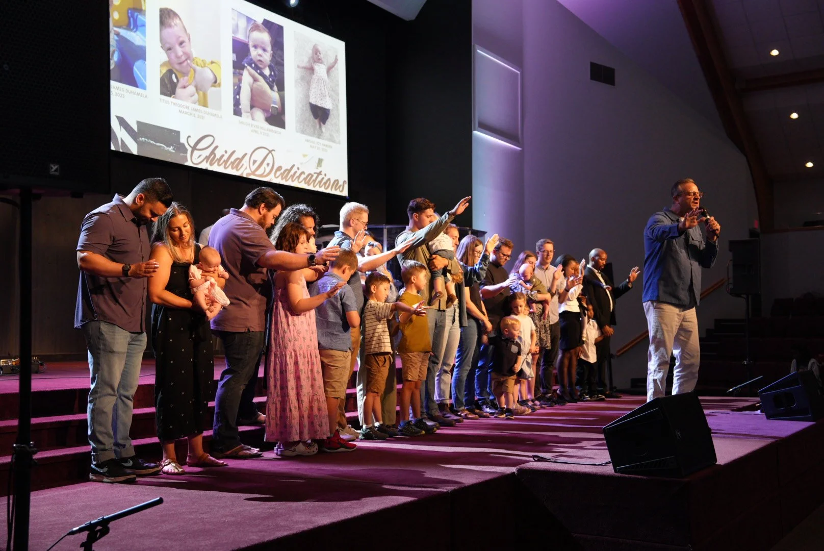 Families dedicating their children on stage at Journey Church Calgary
