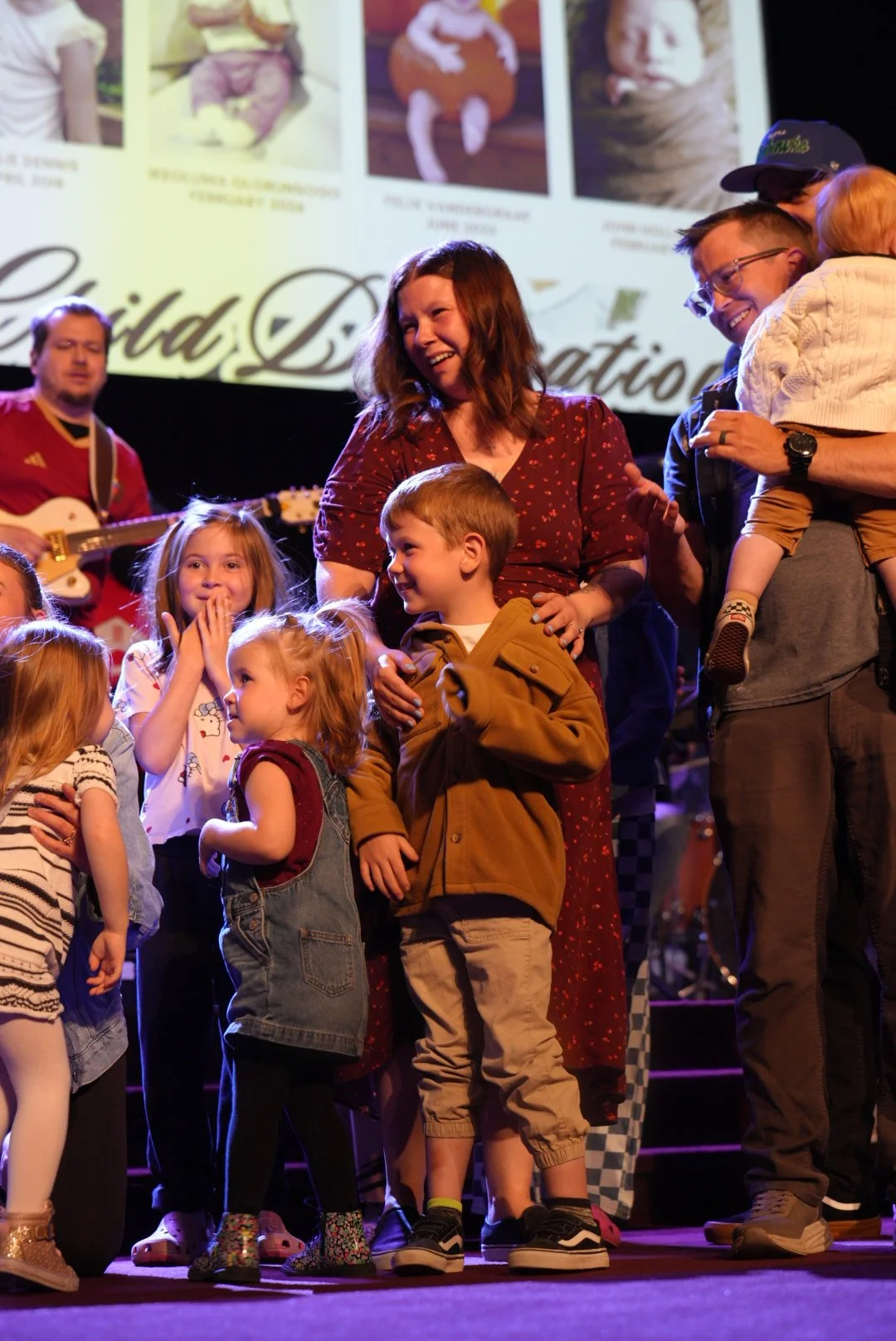 A family with their children on stage for child dedication at Journey Church