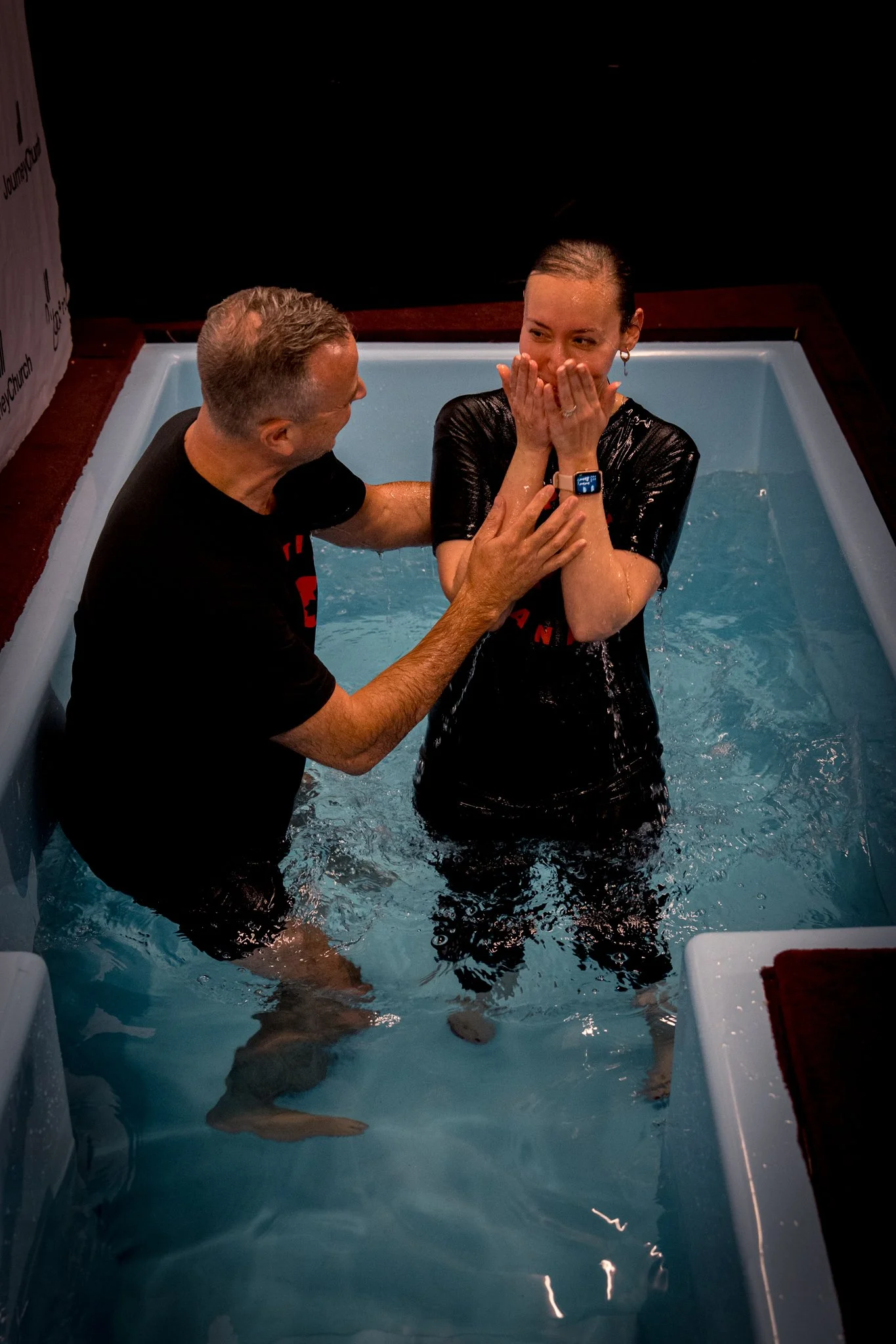 A woman overcome with emotion moments after her baptism
