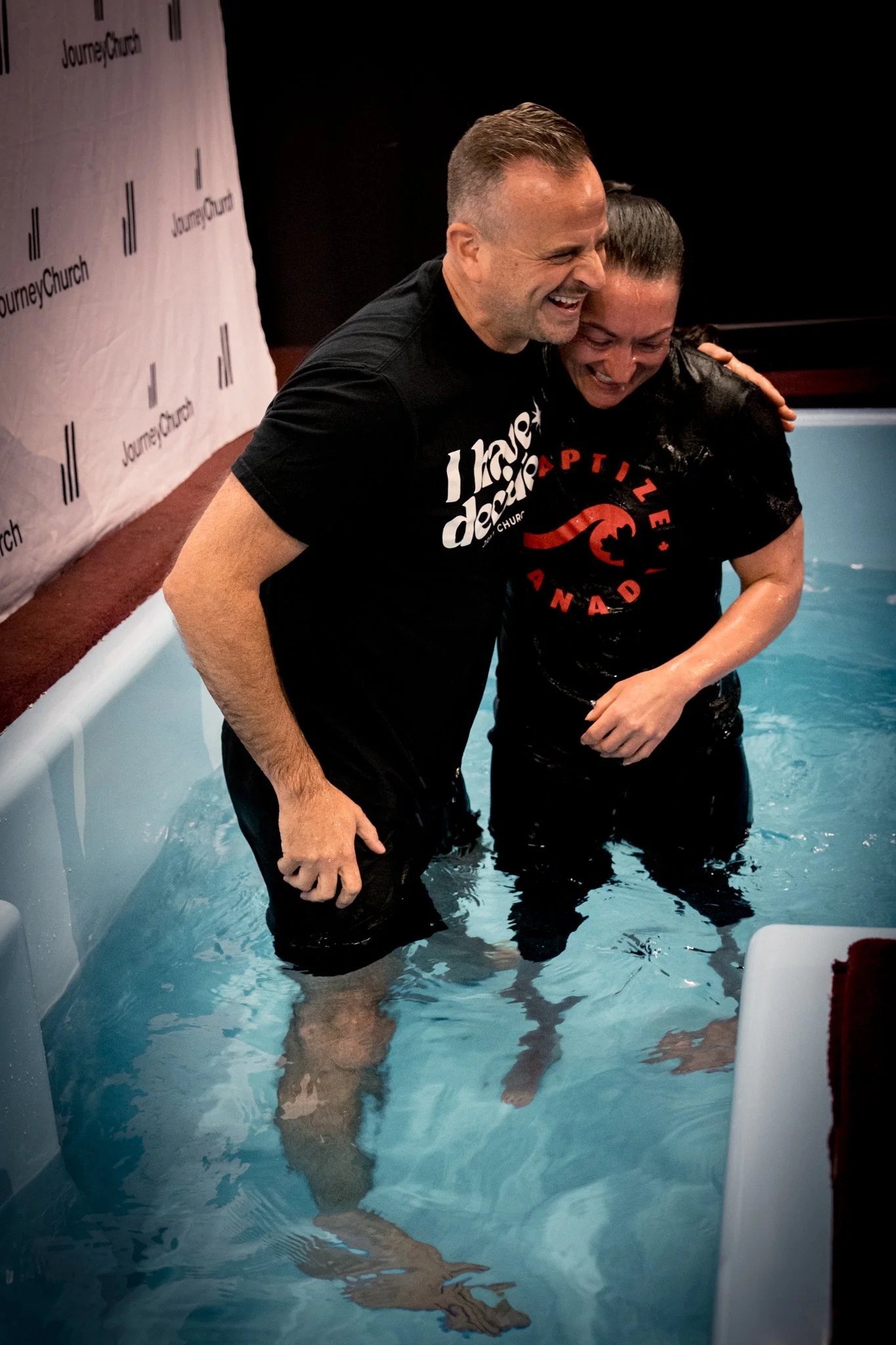 A joyful hug in the water after a baptism at Journey Church