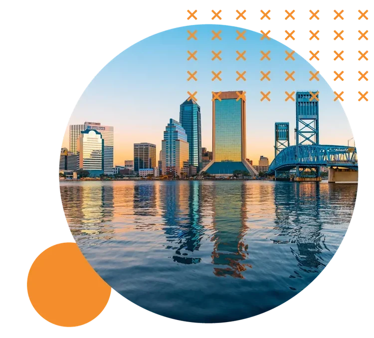 Downtown Jacksonville and the blue Main Street Bridge reflected in the St. Johns River under a golden sky