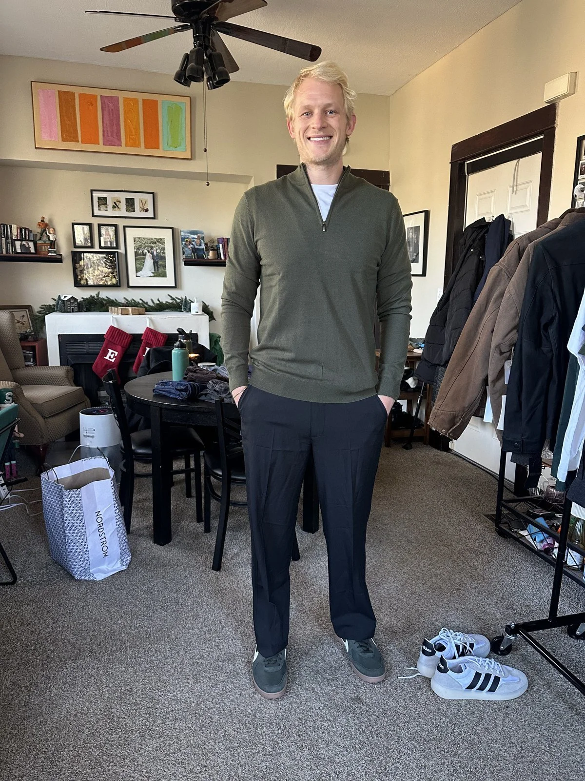 Client wearing an olive zip sweater with dark trousers