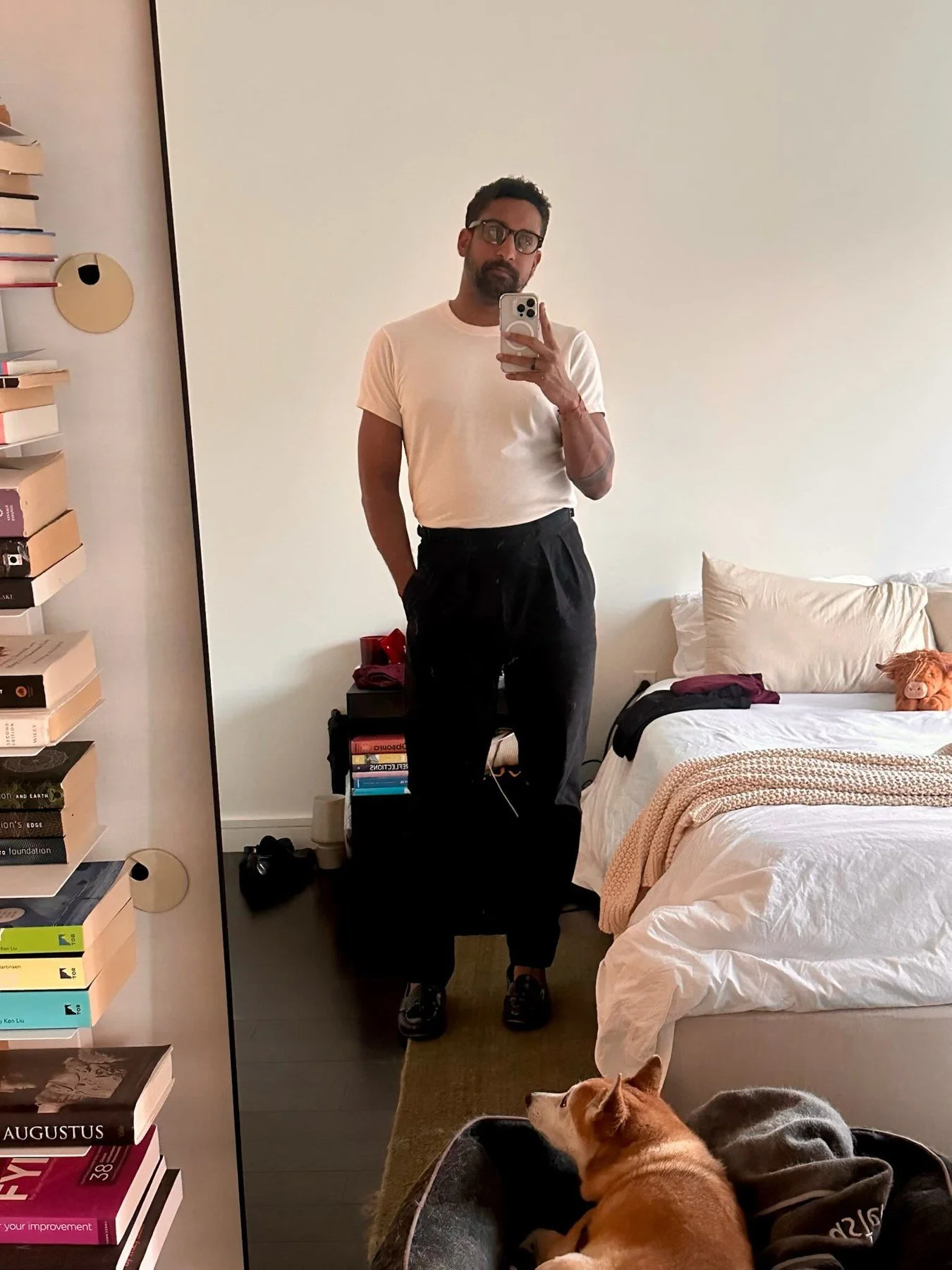 Real client mirror photo wearing a white tee and black trousers.