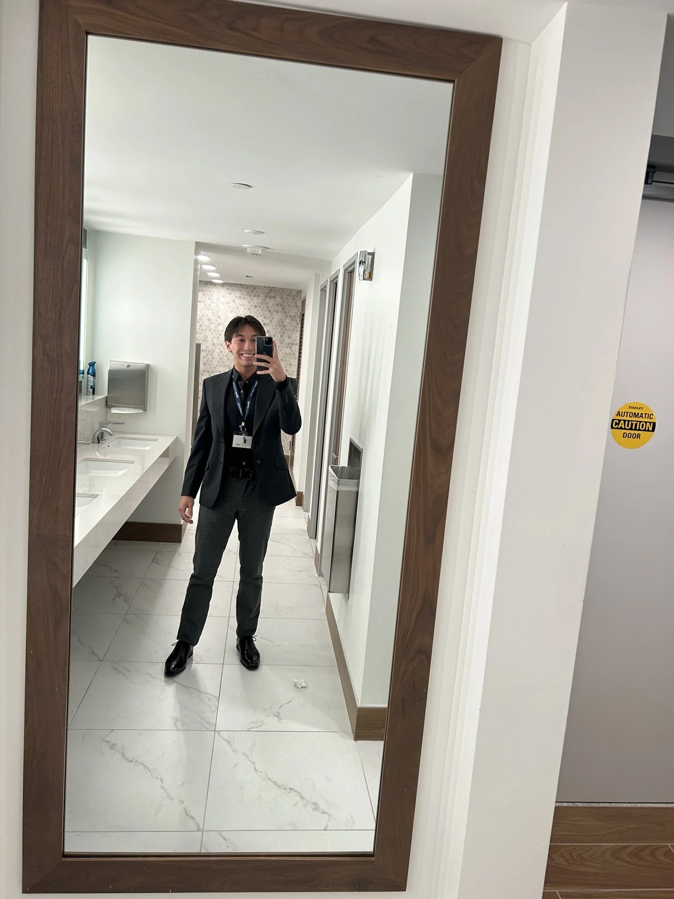 Dark blazer and shirt with gray trousers