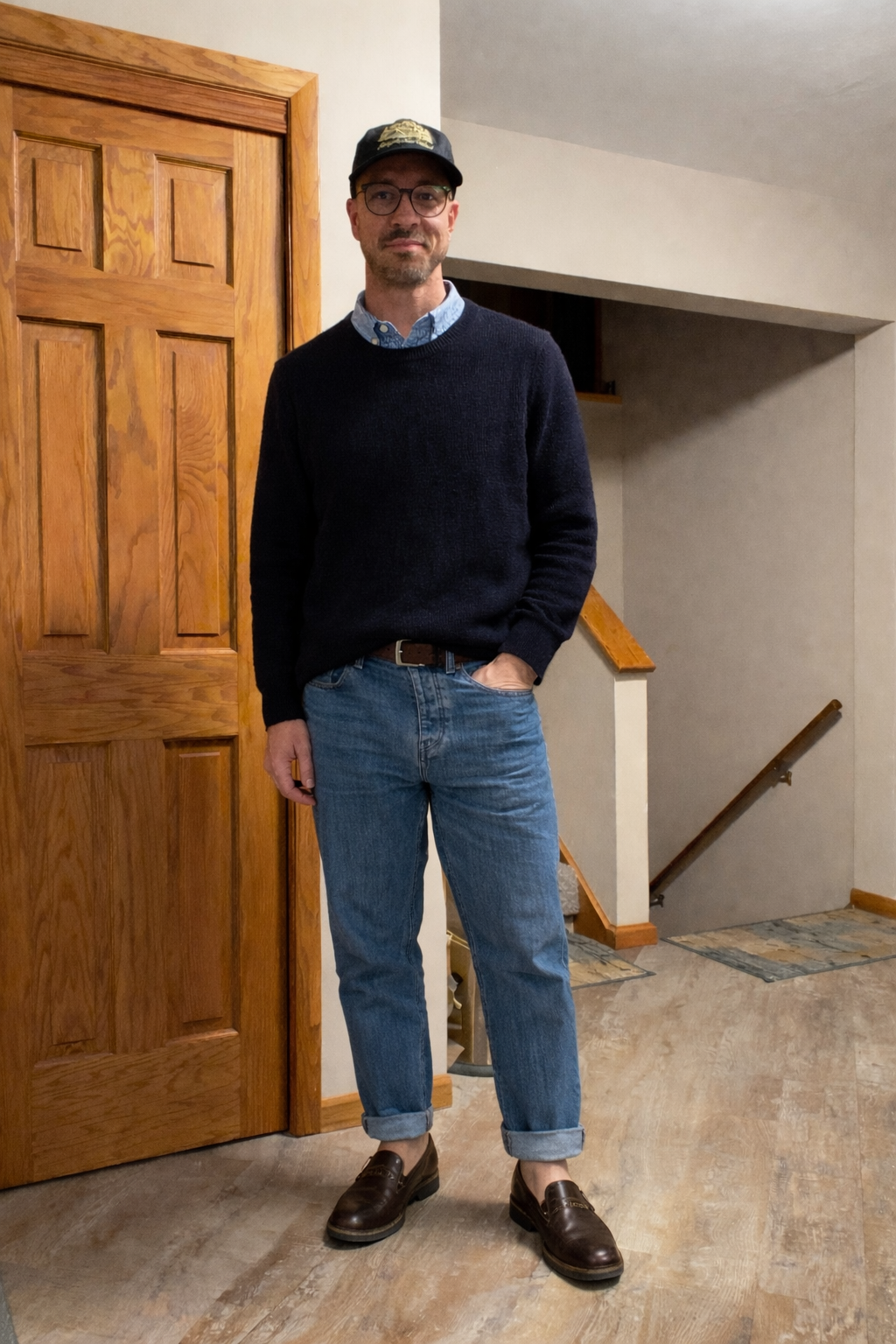Navy knit and cuffed denim styled with brown loafers