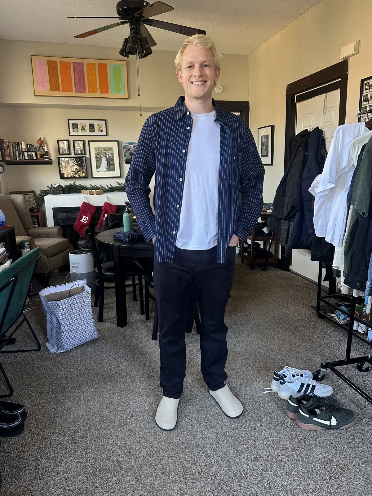 Client wearing a navy overshirt with dark trousers and cream shoes