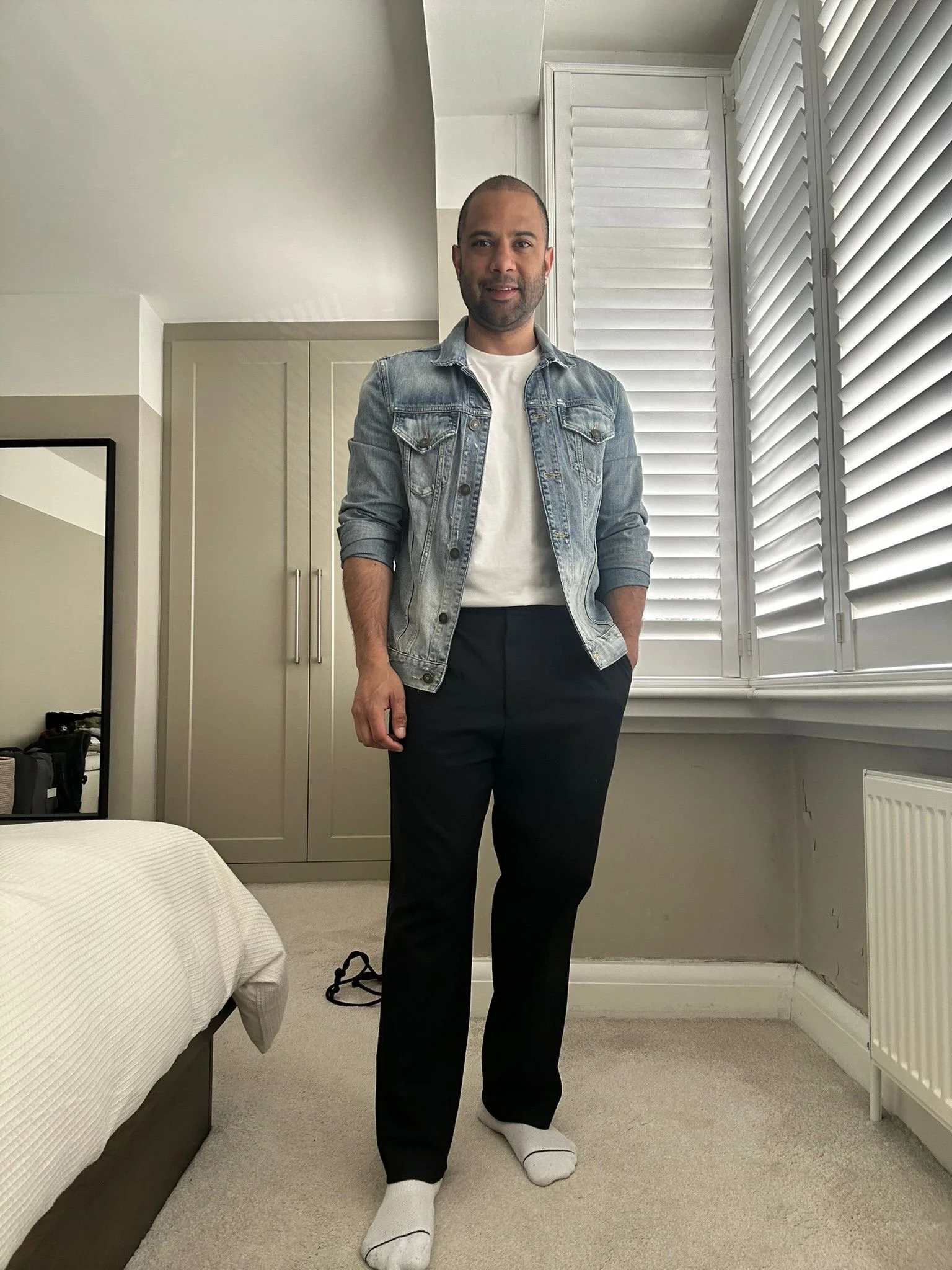After styling: client wearing a denim jacket, white shirt, and dark trousers.