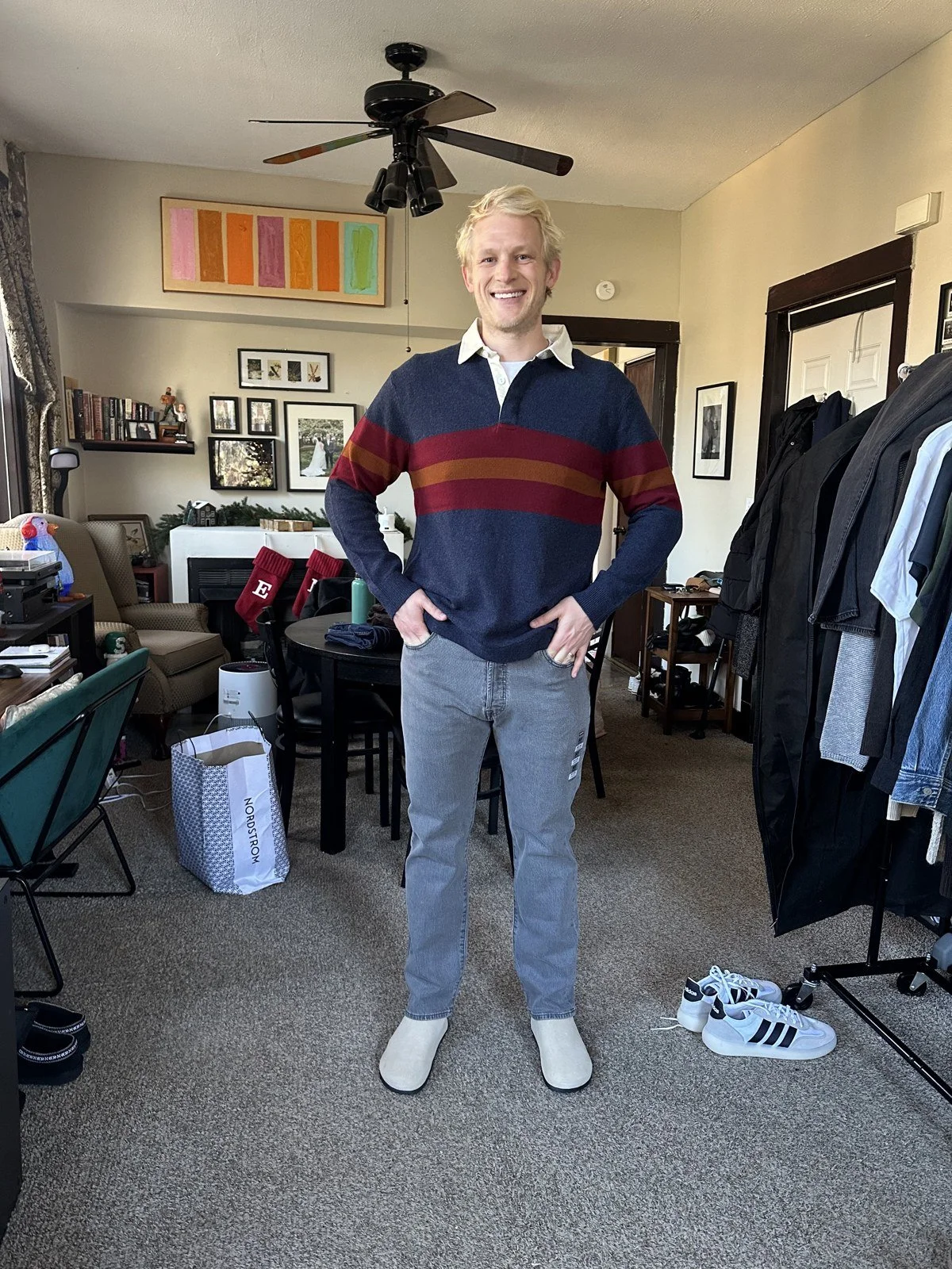 Client wearing a striped rugby shirt with gray trousers