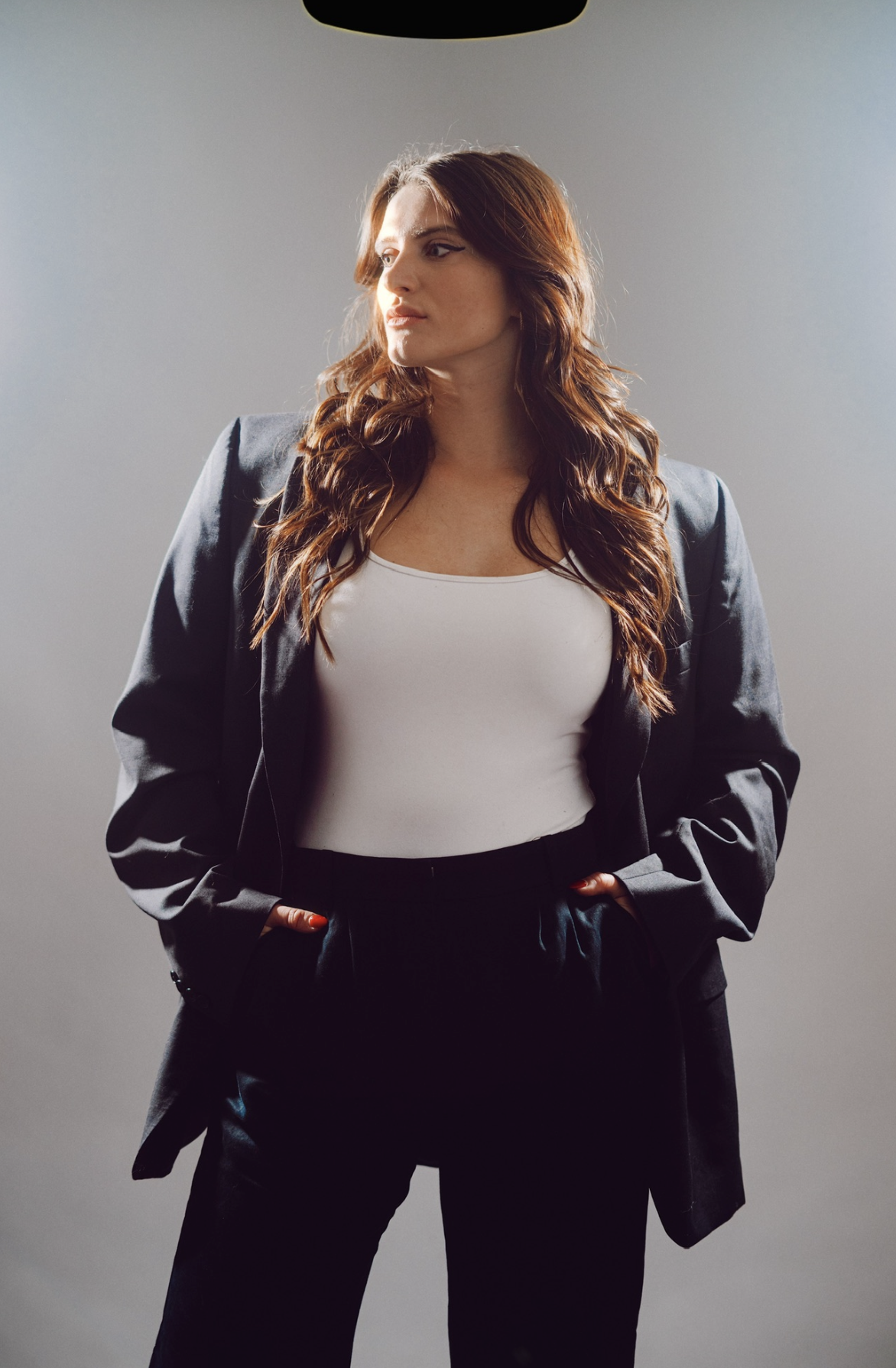 Portrait of Jax in a dark blazer and white top