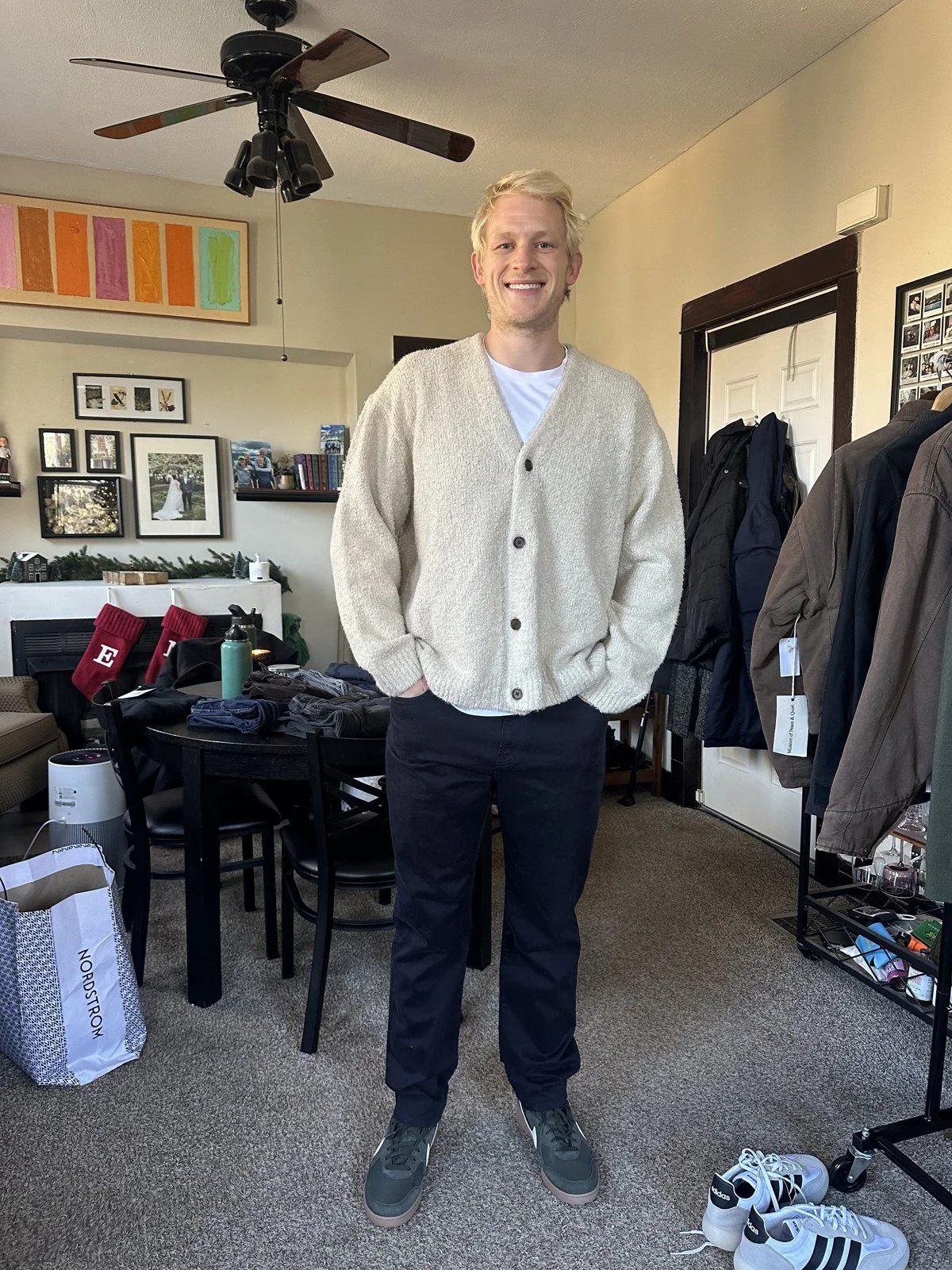 Client wearing a cream cardigan with dark trousers