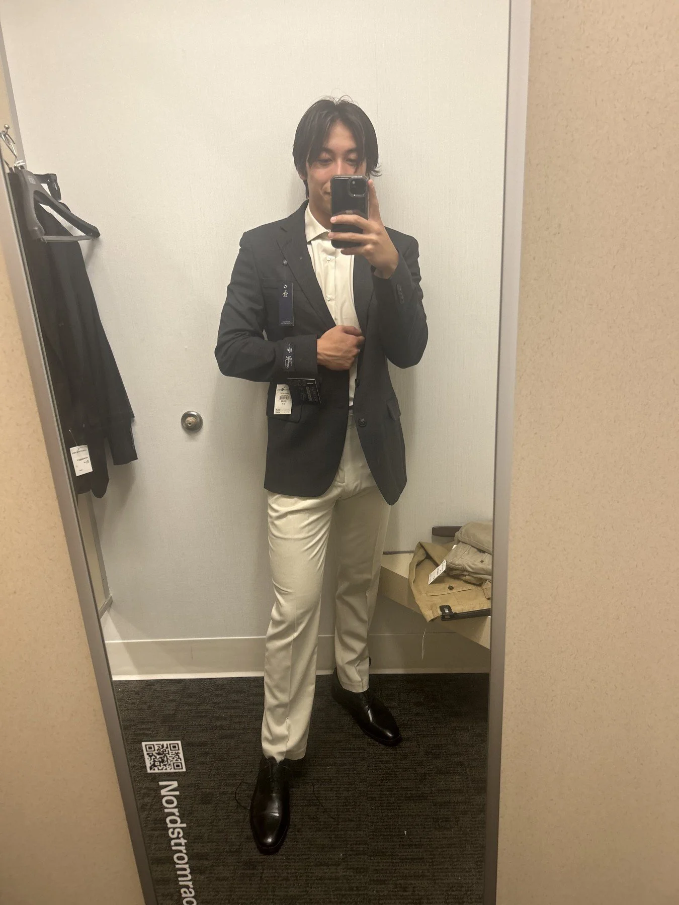 Fitting-room look with a dark blazer and cream trousers