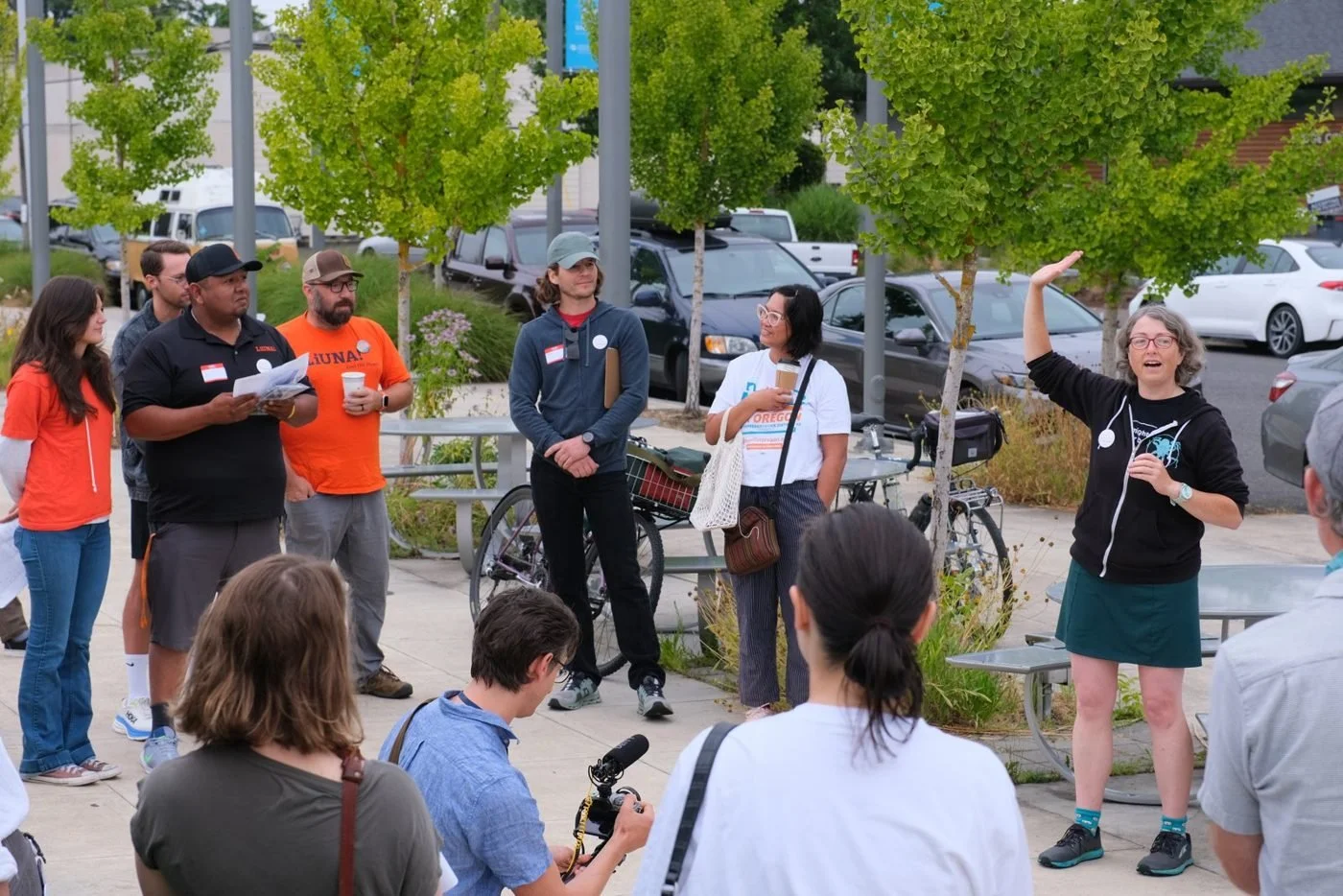 Steph speaking to a group of neighbors and organizers