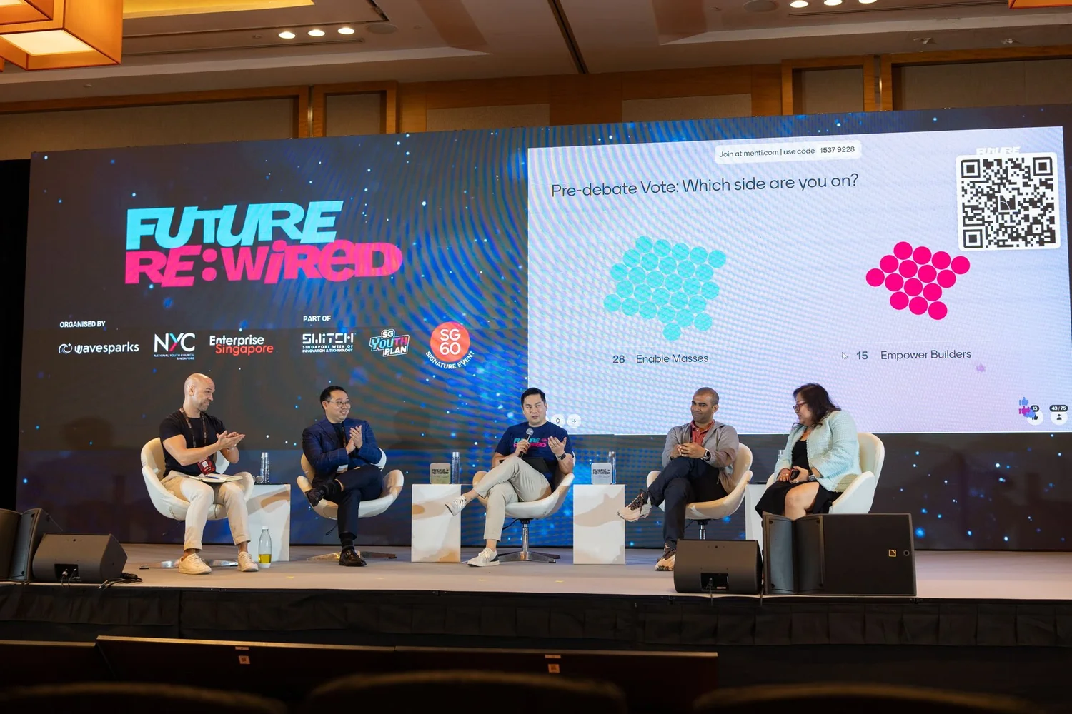 ThinkClash panelists discuss AI while the audience vote appears on screen