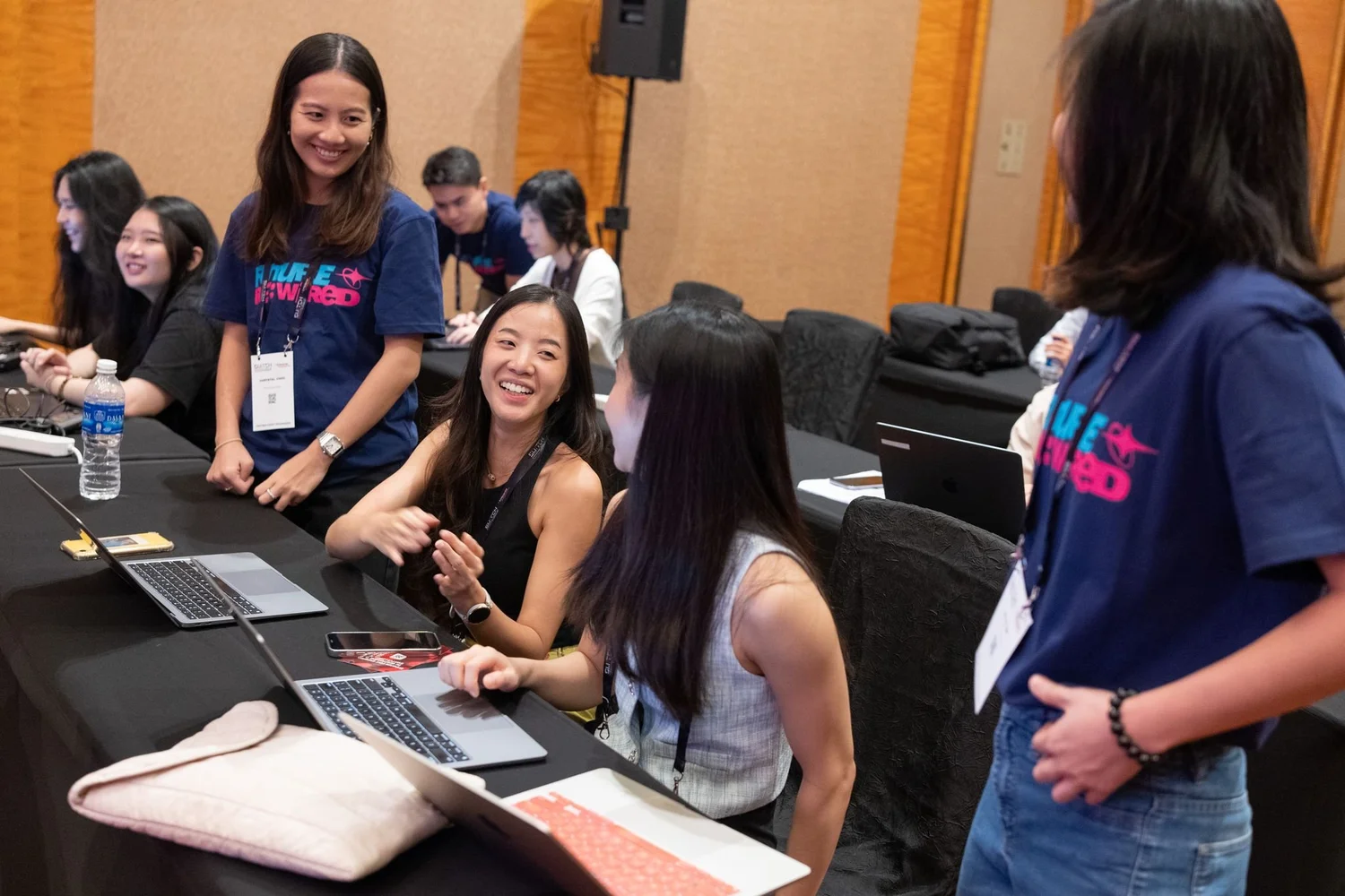 Youth collaborate on laptops during an AIdea Labs session