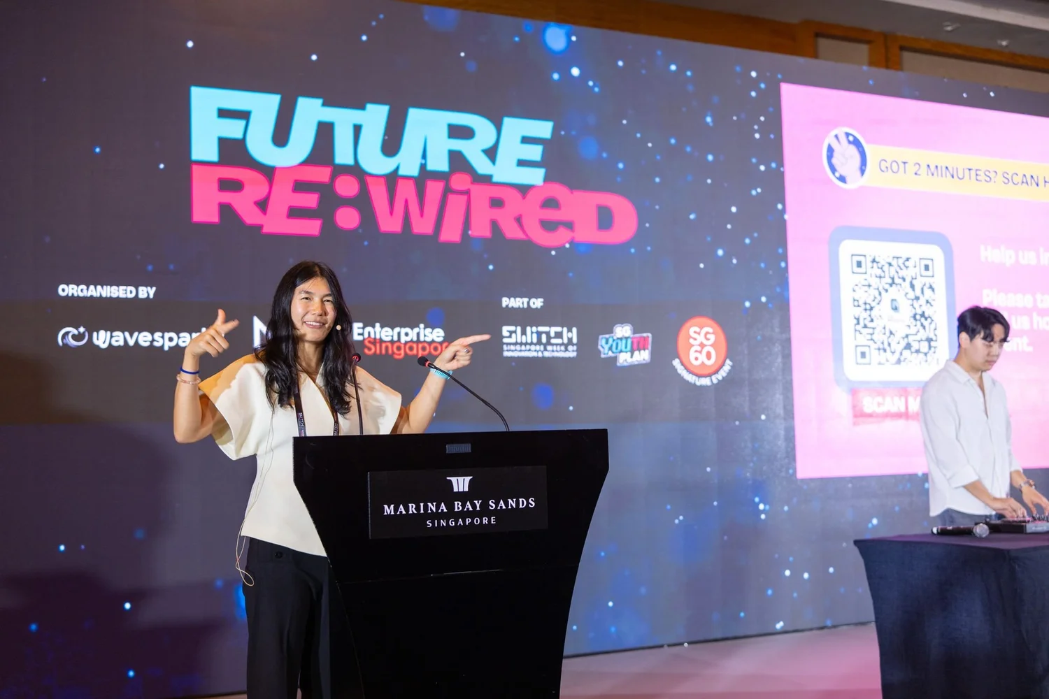 A speaker welcomes youth to Future Re:Wired at Marina Bay Sands Convention Centre