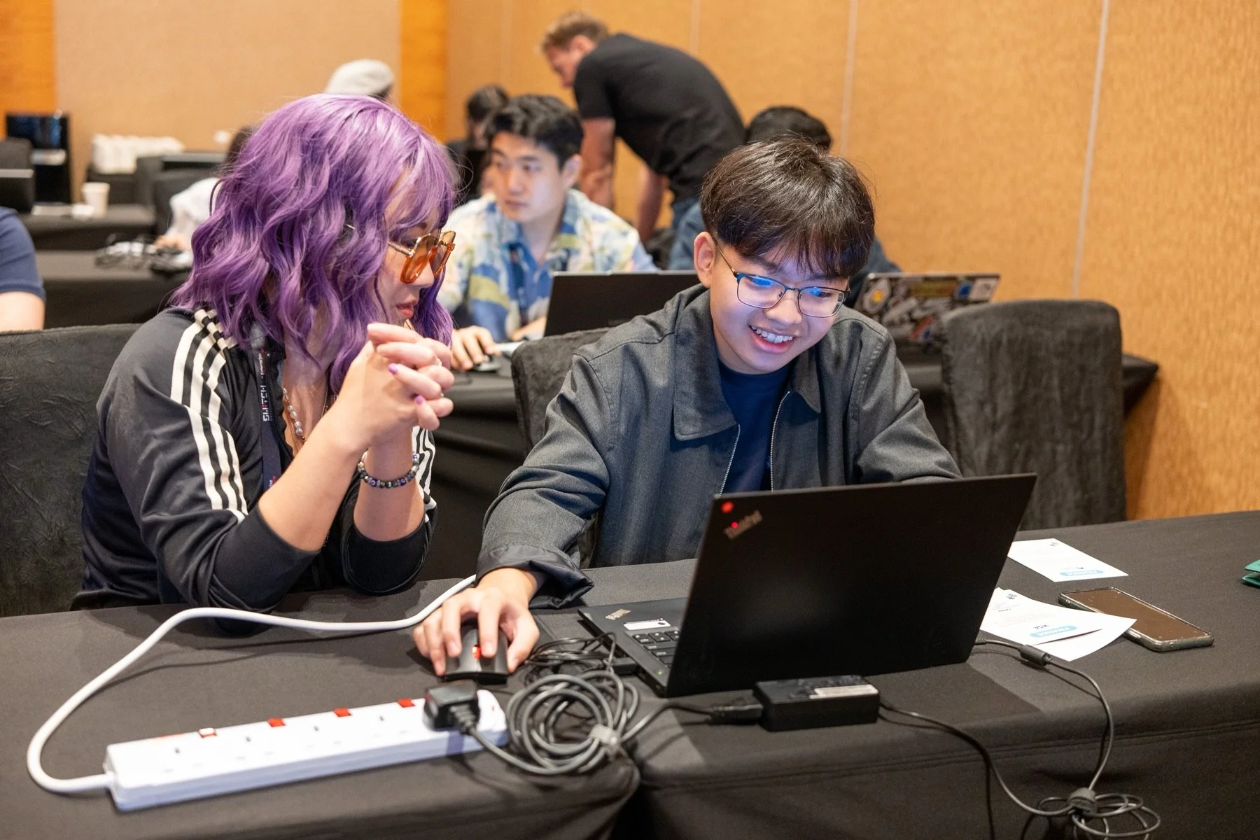 Two youth participants collaborate on a laptop during AIdea Labs