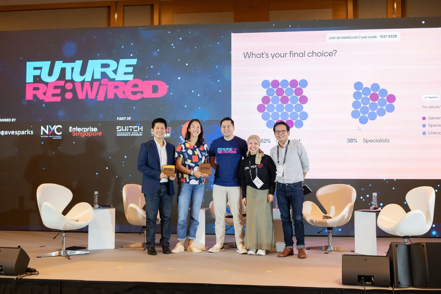 ThinkClash speakers pose on stage after the live debate