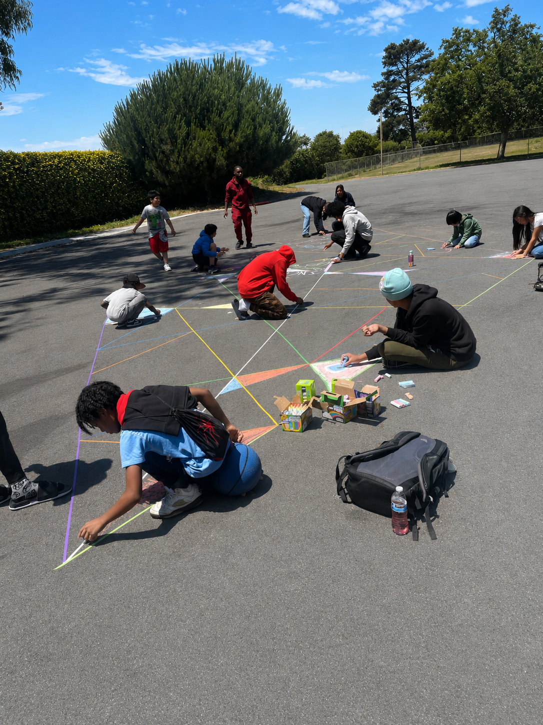 Young people creating colorful chalk art