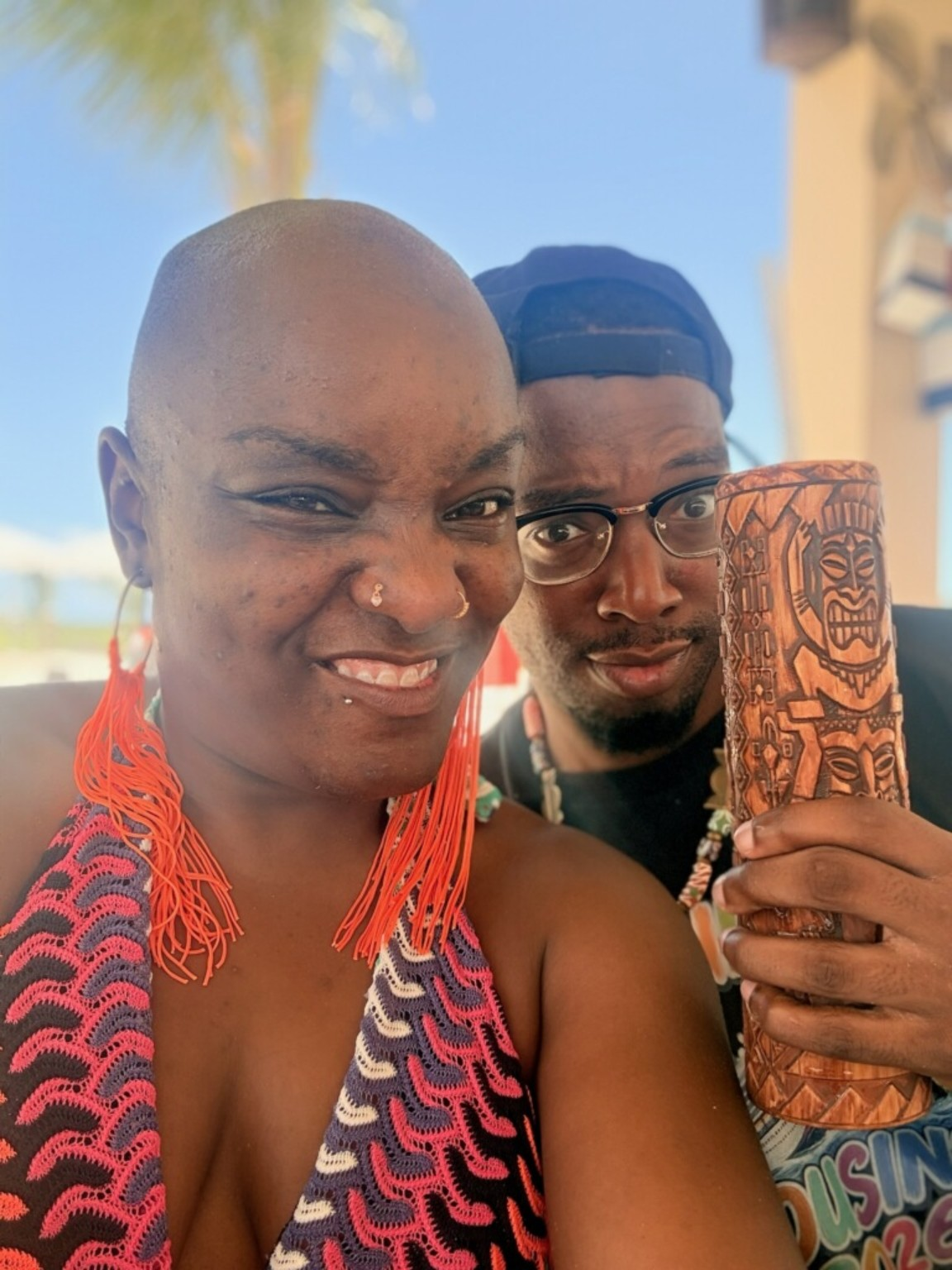 Anorah and Reggie with a carved tiki cup