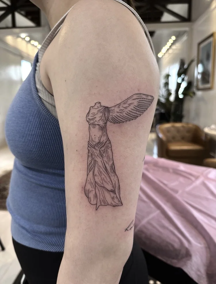 Winged Victory fine-line tattoo