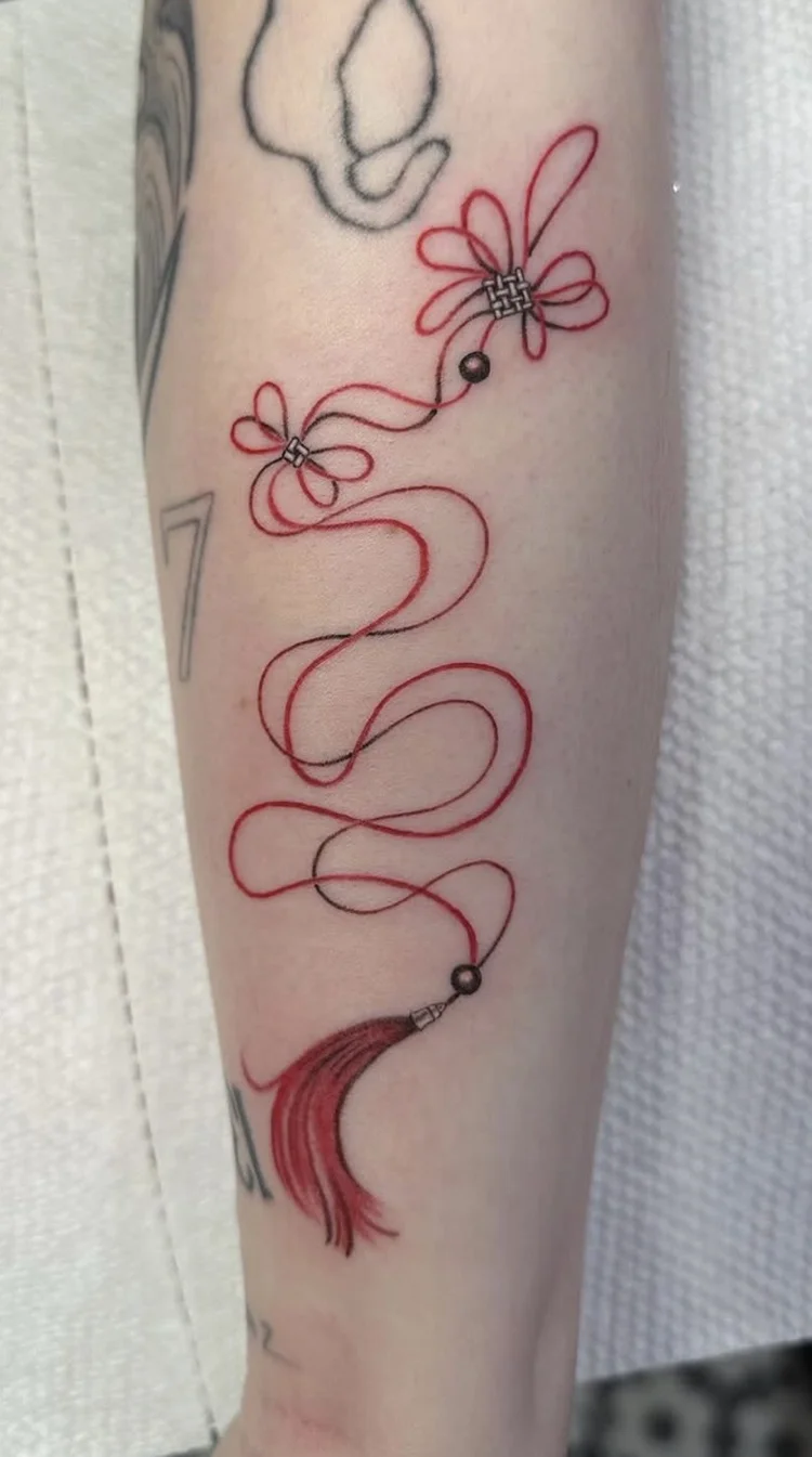 Red Thread & Tassel fine-line tattoo
