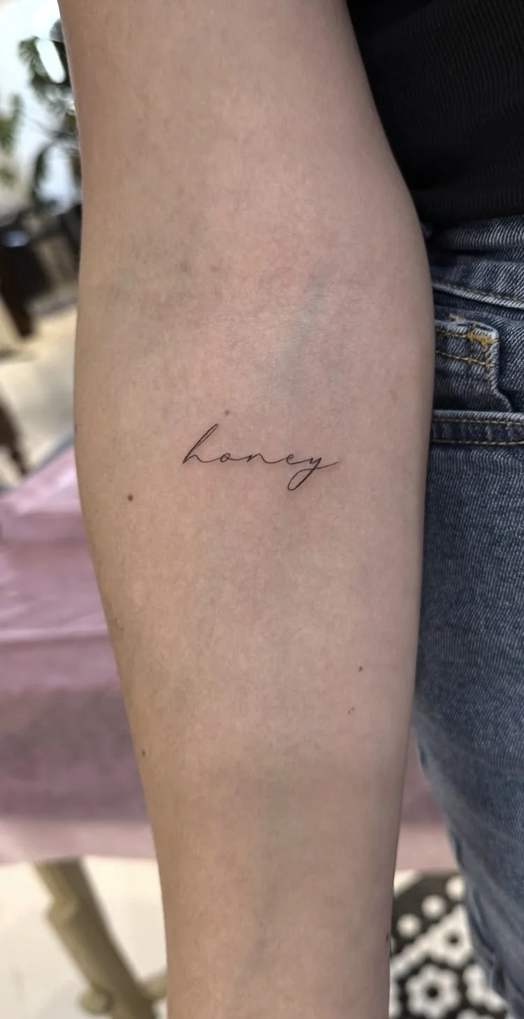 Honey Script fine-line tattoo