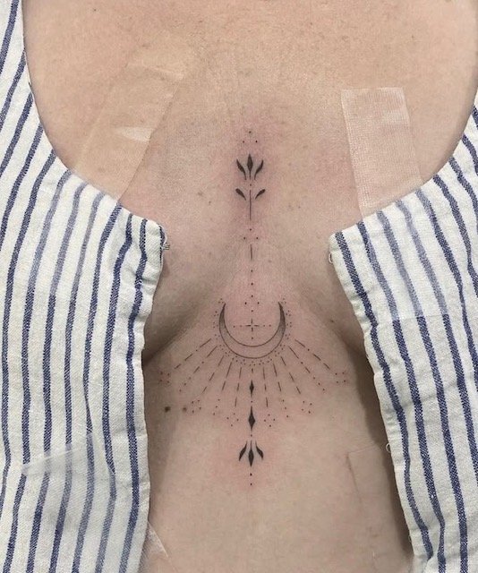 Sunburst Sternum fine-line tattoo