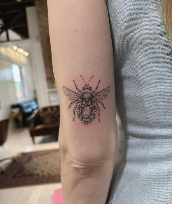 Bee fine-line tattoo