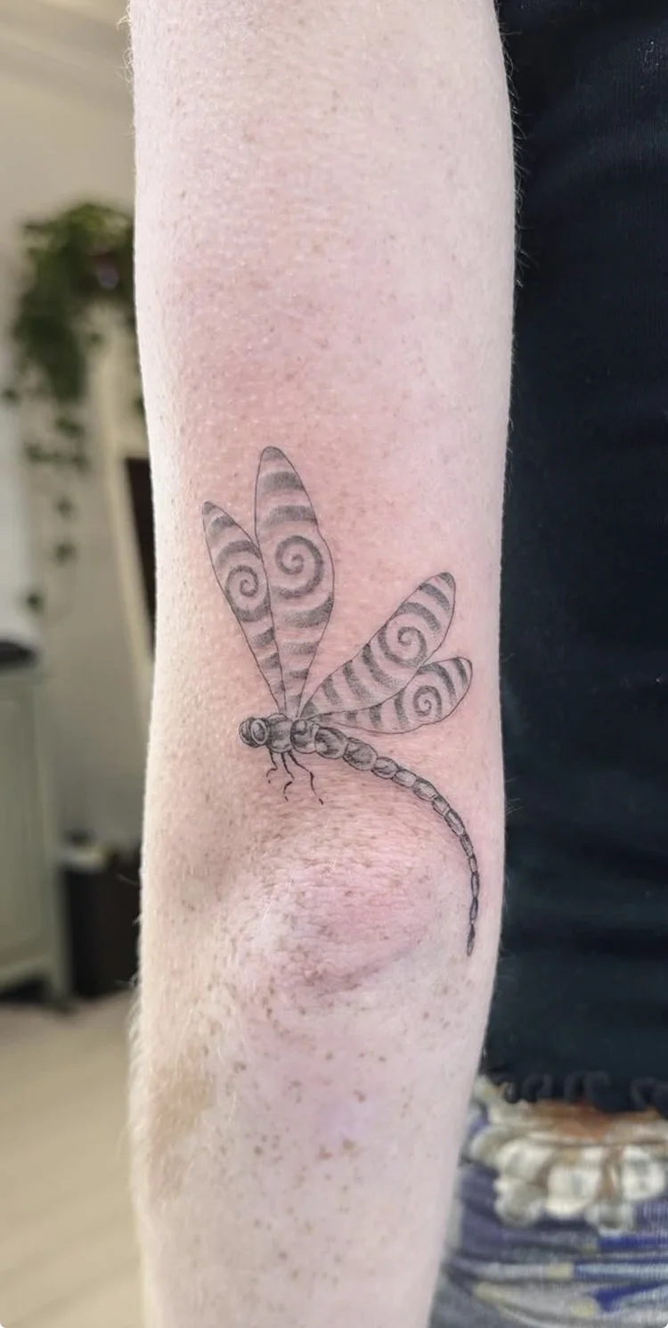 Dragonfly fine-line tattoo