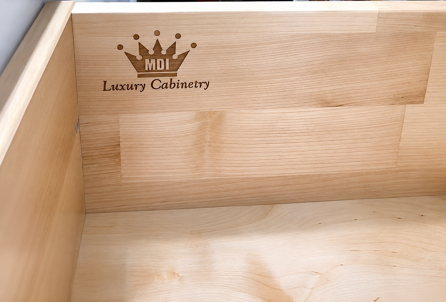 Real dovetail drawer laser engraved with the registered MDI Luxury Cabinetry mark