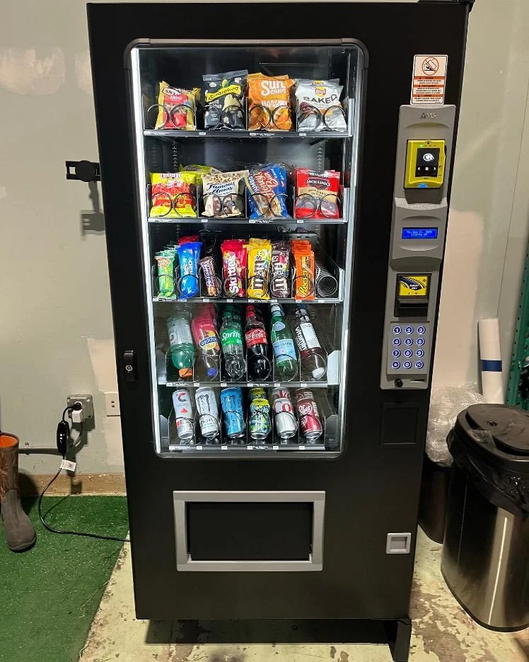 Installed BobbySnaqs combo vending machine stocked with chips, candy and cold drinks