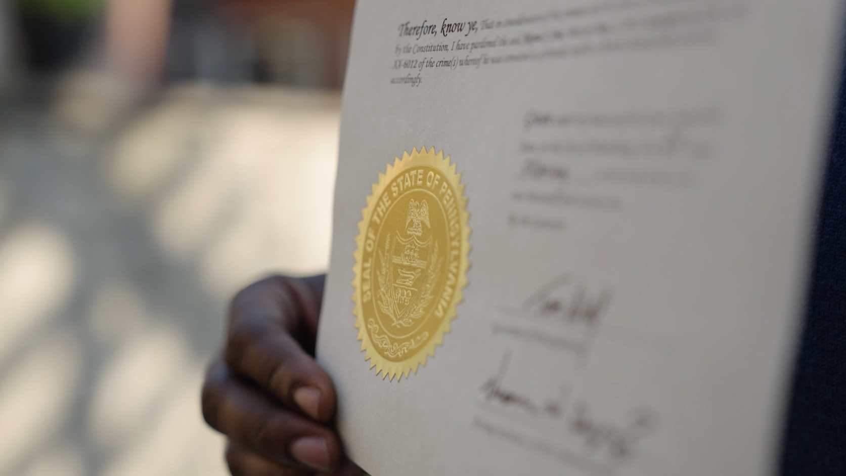 Person holding a Pennsylvania pardon certificate