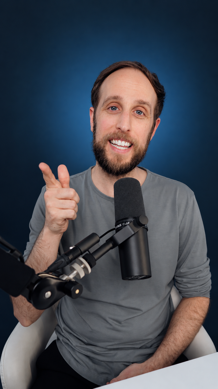 David Martin smiling at his studio microphone.