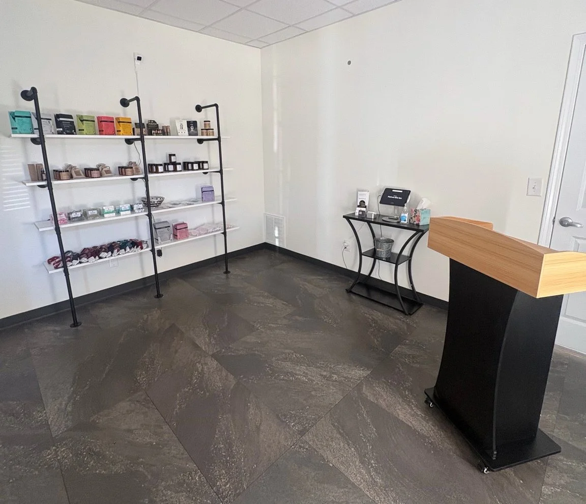 Reception desk and retail shelves at our Oconee spa
