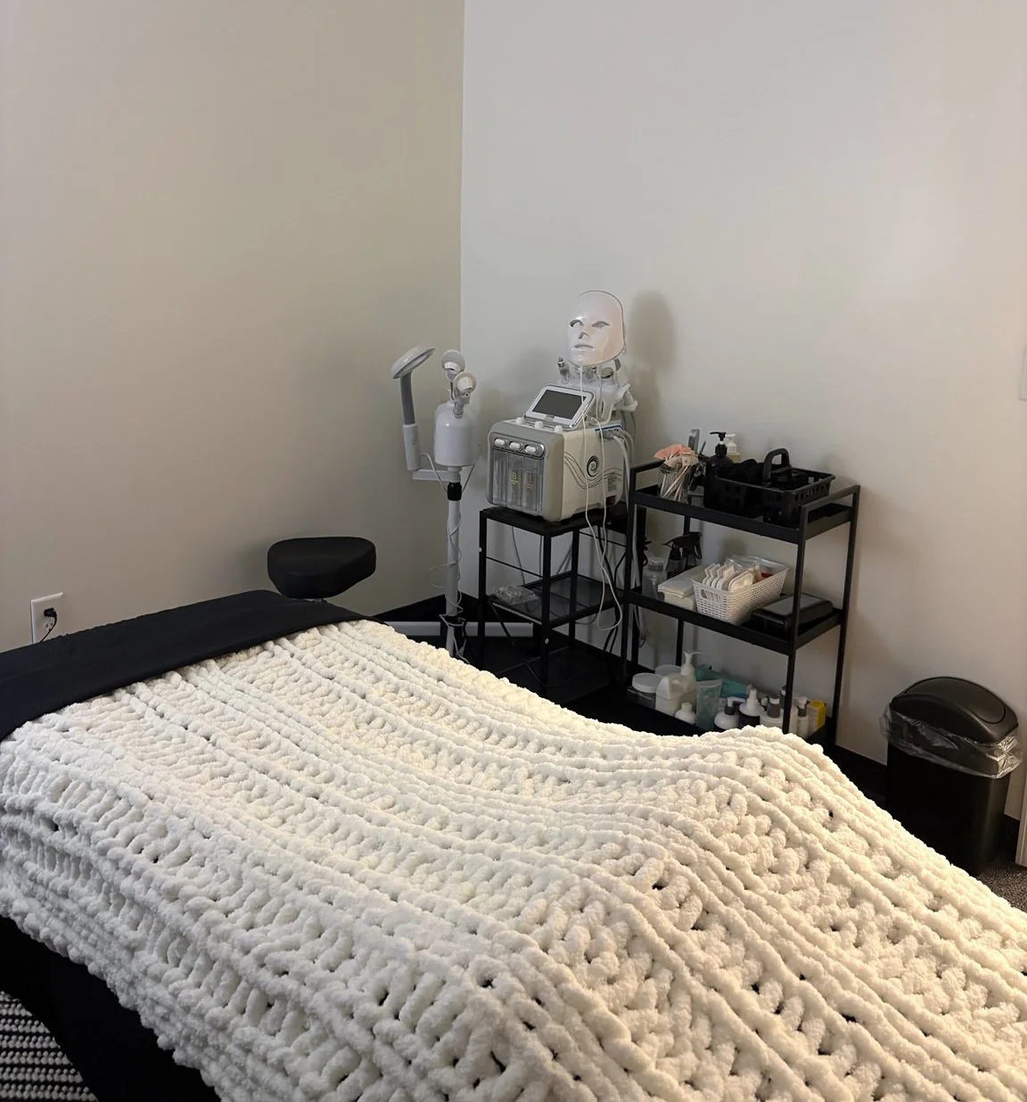 Treatment bed and skincare equipment in our Oconee facial room