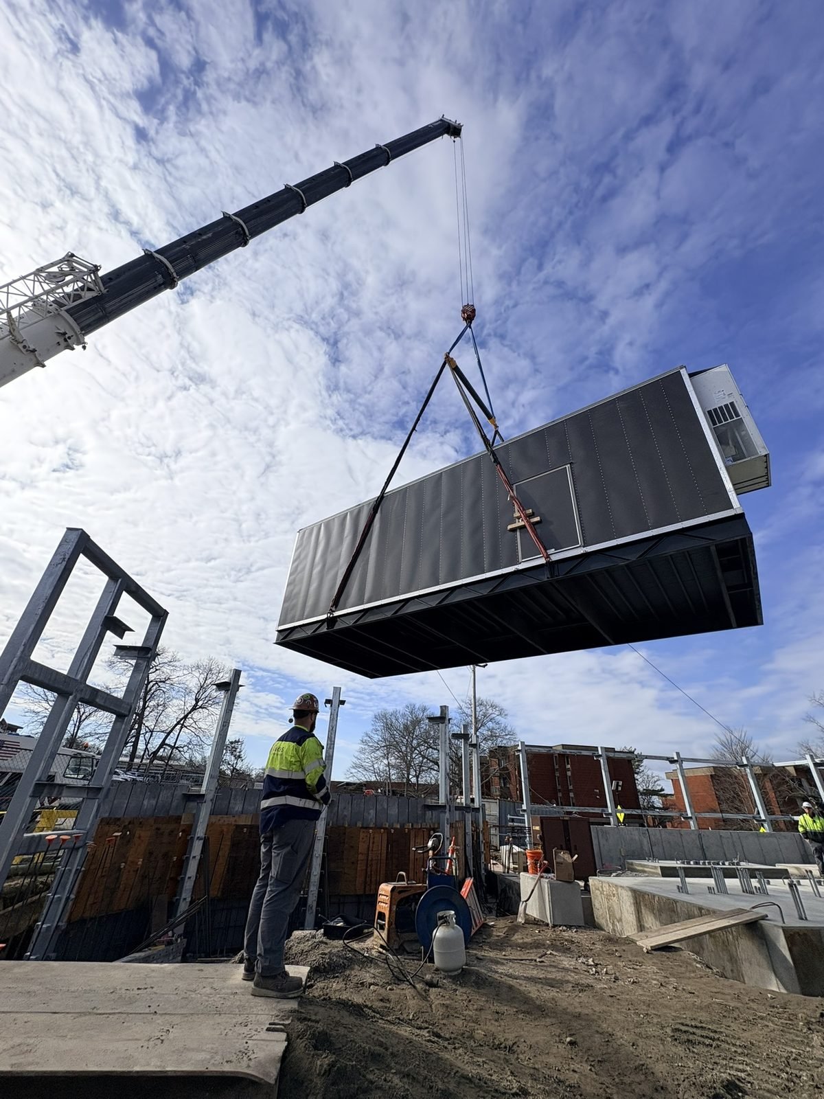 Crane flying a modular unit into place in South Kingstown, RI