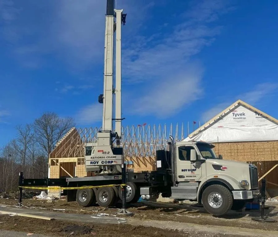 Crane setting roof trusses in Uxbridge, MA