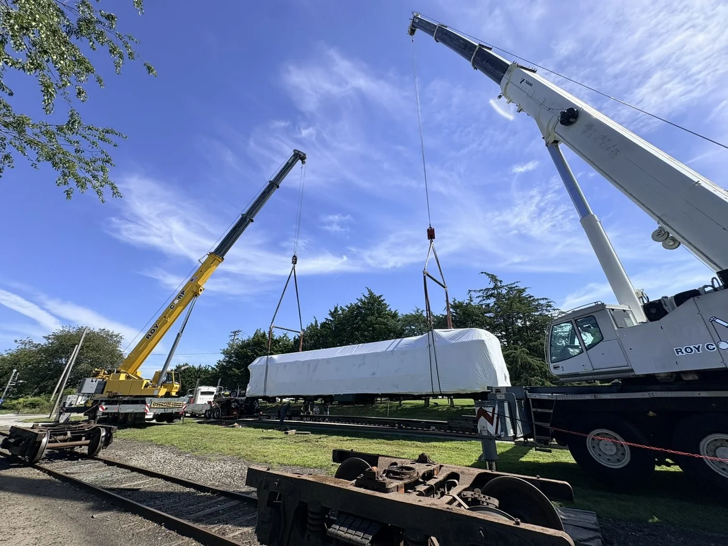 Two Roy Corp cranes performing a tandem lift of a train car in Portsmouth, RI